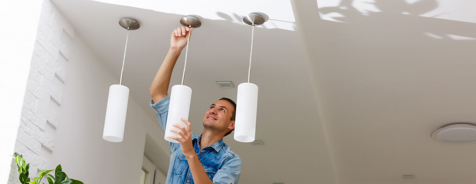 An electrician working on a light